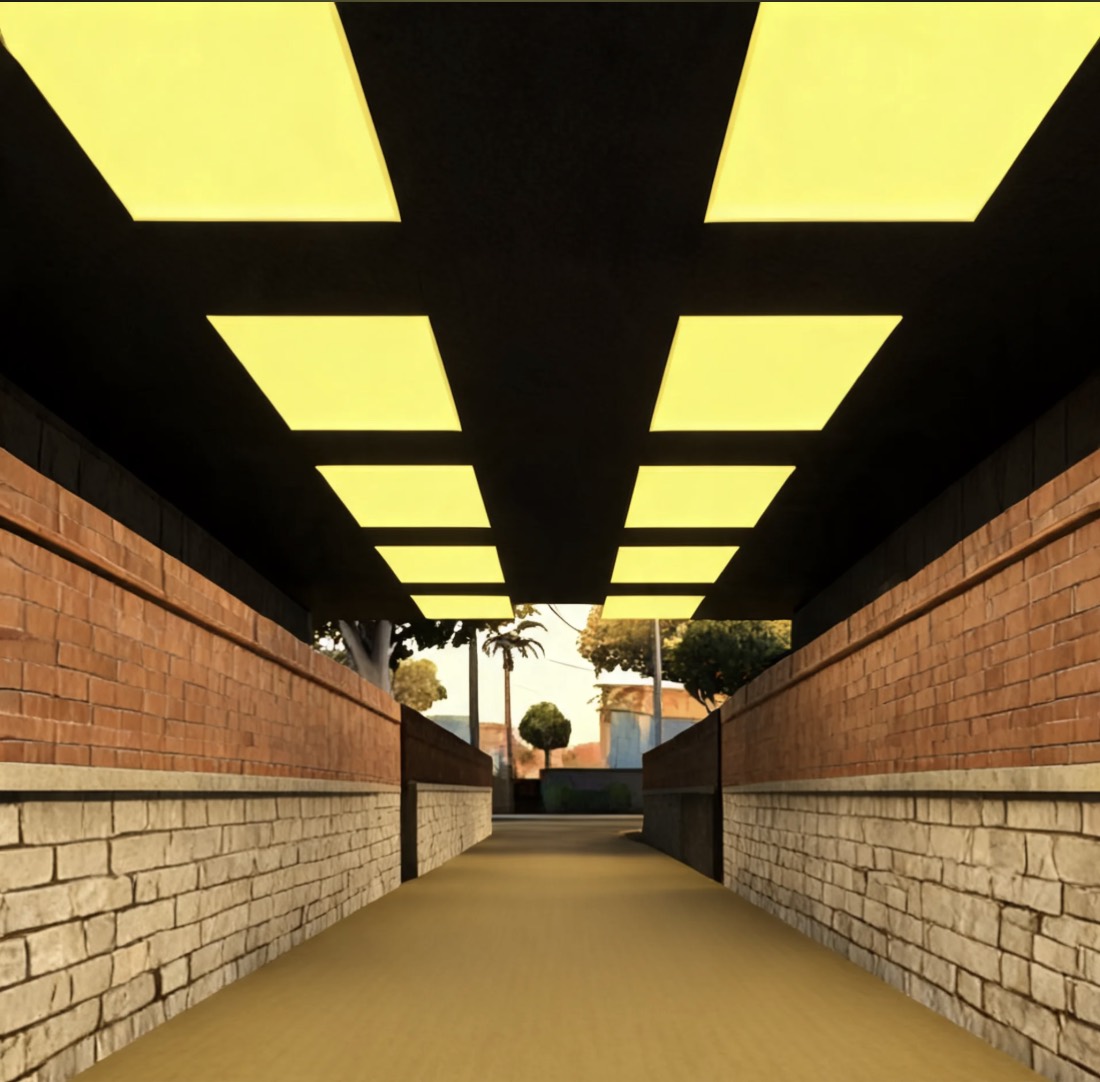 the last hallway: yellow ceiling panels overhead, brick walls, and a street visible at the far end